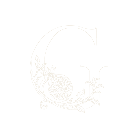 The finished G: the vine turns the bowl of the letter and the split fruit sits at the spur.